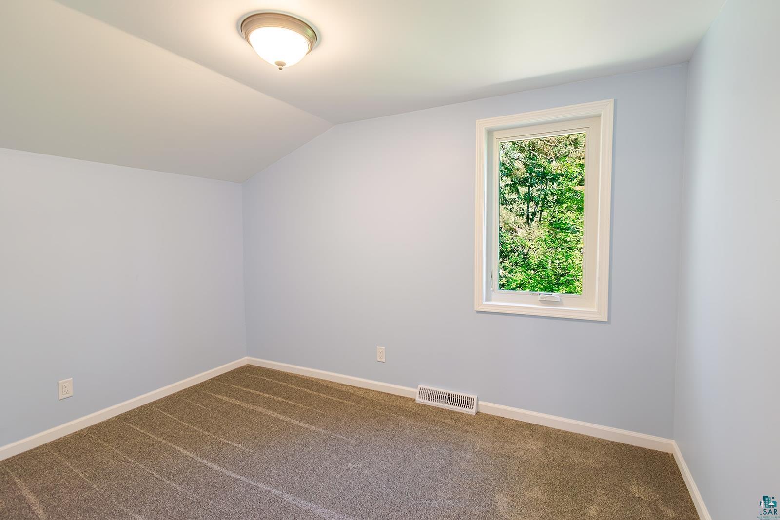 29 Ridge Road Esko, MN 55733 - Photo 23 of 41 Room featuring light blue walls, white trim, and patterned carpeting