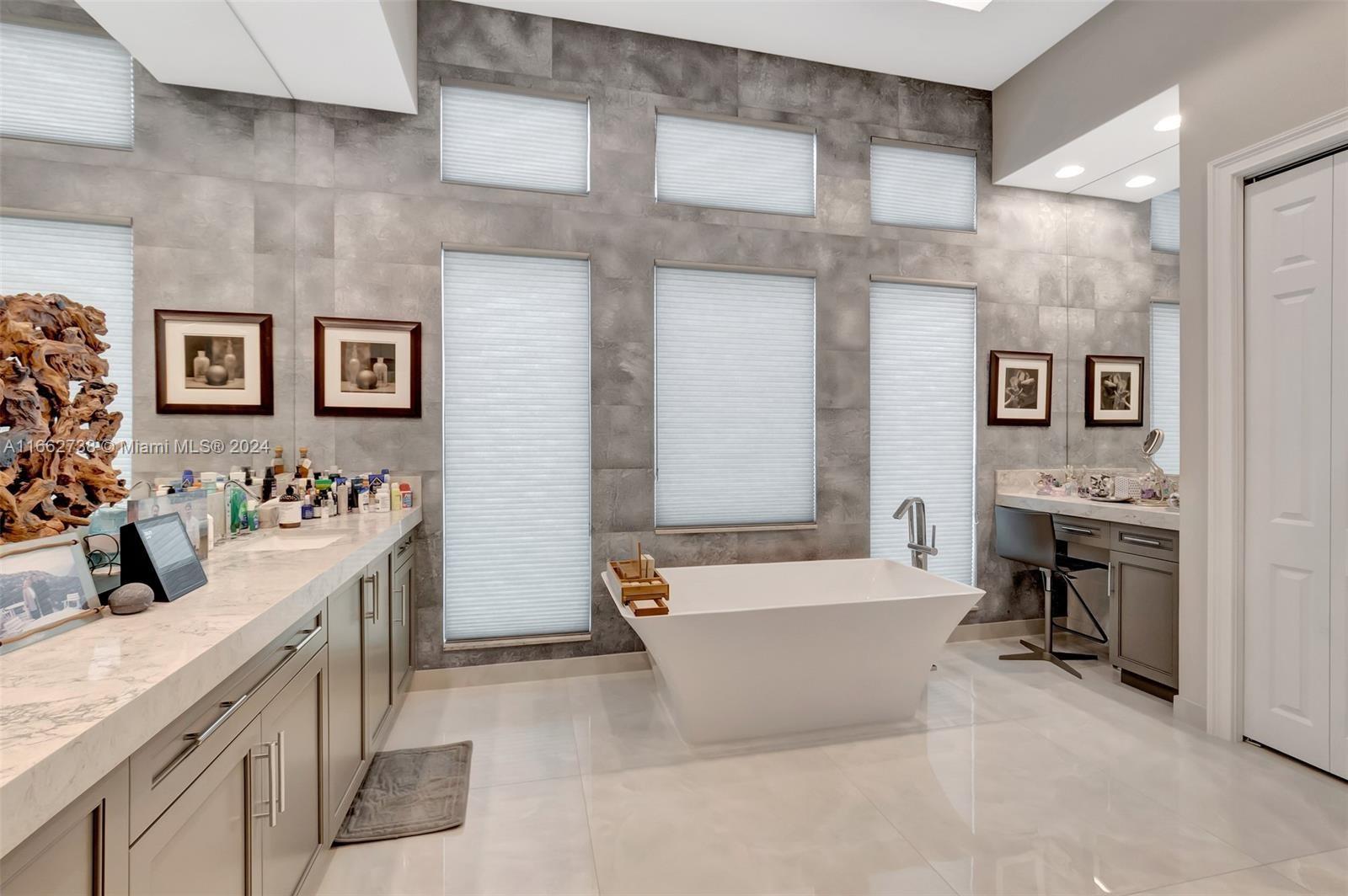 17430 Rosella Road Boca Raton, FL 33496 - Photo 12 of 23 a spacious bathroom with a tub a double vanity sink and mirror