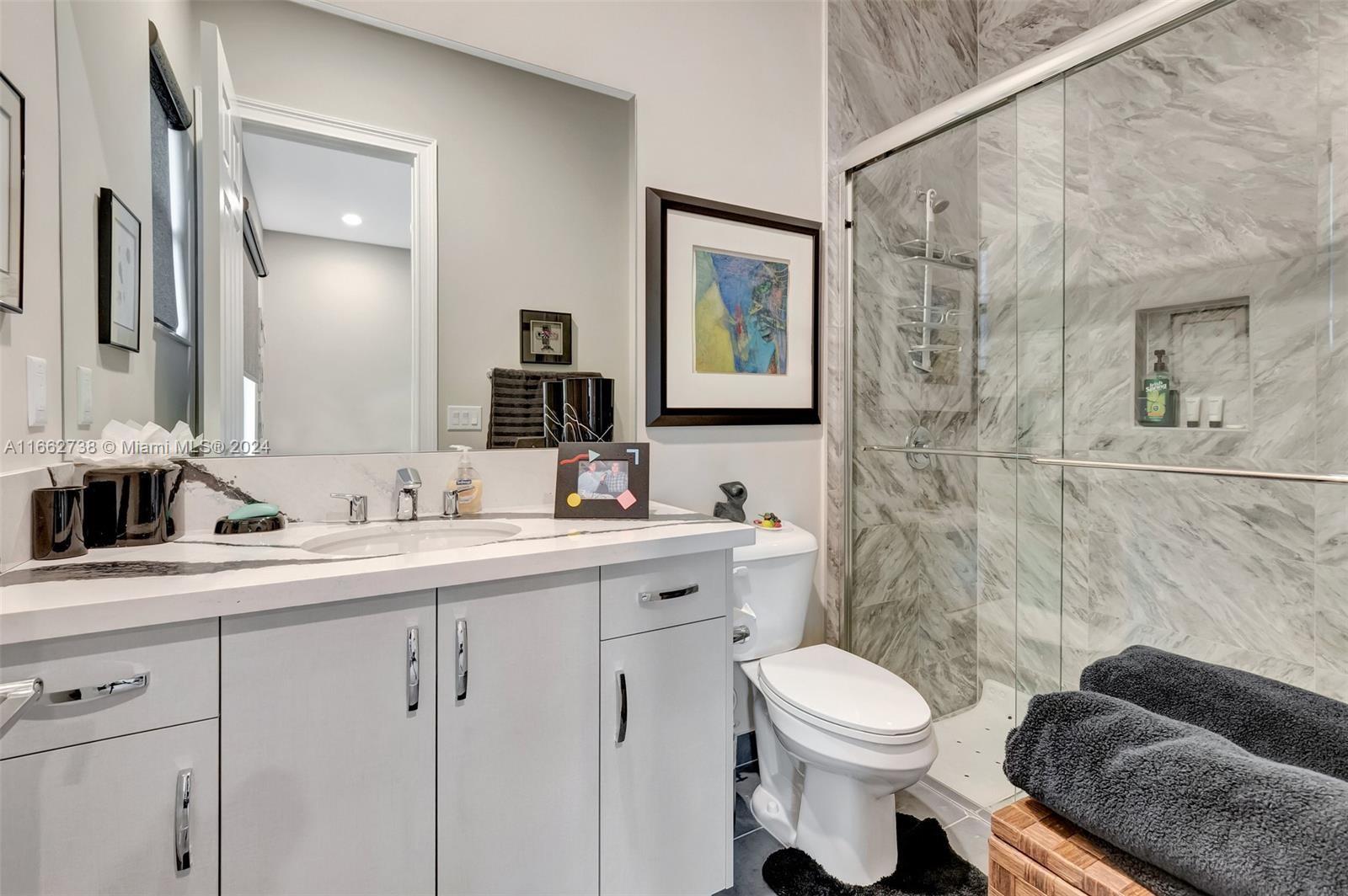 17430 Rosella Road Boca Raton, FL 33496 - Photo 15 of 23 a bathroom with a toilet a sink and mirror