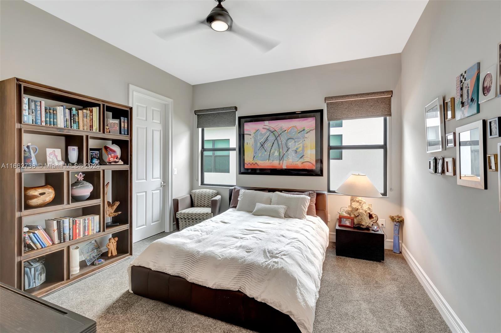 17430 Rosella Road Boca Raton, FL 33496 - Photo 16 of 23 a bedroom with a bed and a book shelf