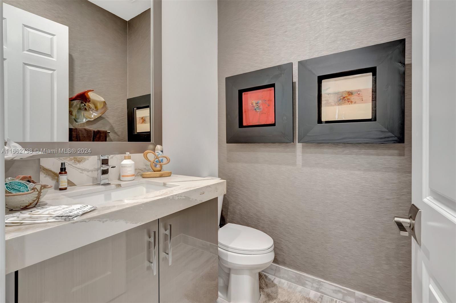 17430 Rosella Road Boca Raton, FL 33496 - Photo 17 of 23 a bathroom with a toilet a sink and mirror