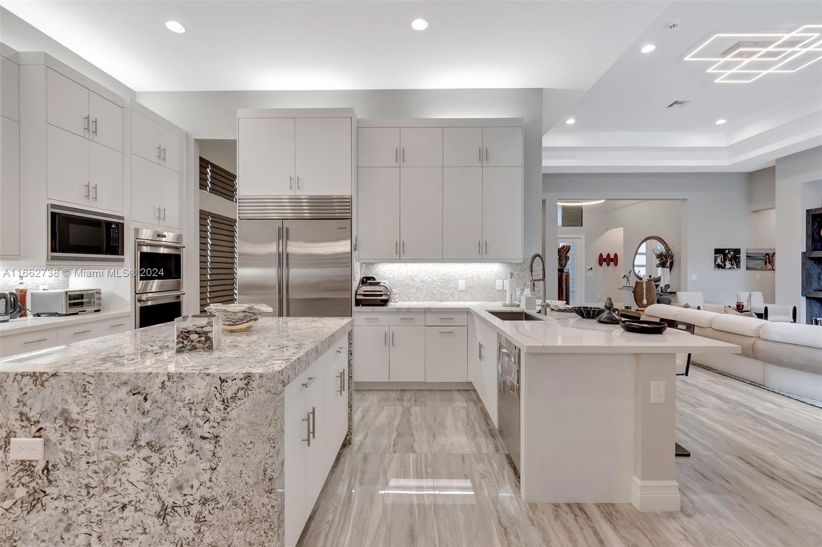17430 Rosella Road Boca Raton, FL 33496 - Photo 3 of 23 a kitchen with stainless steel appliances kitchen island granite countertop a sink stove refrigerator and cabinets