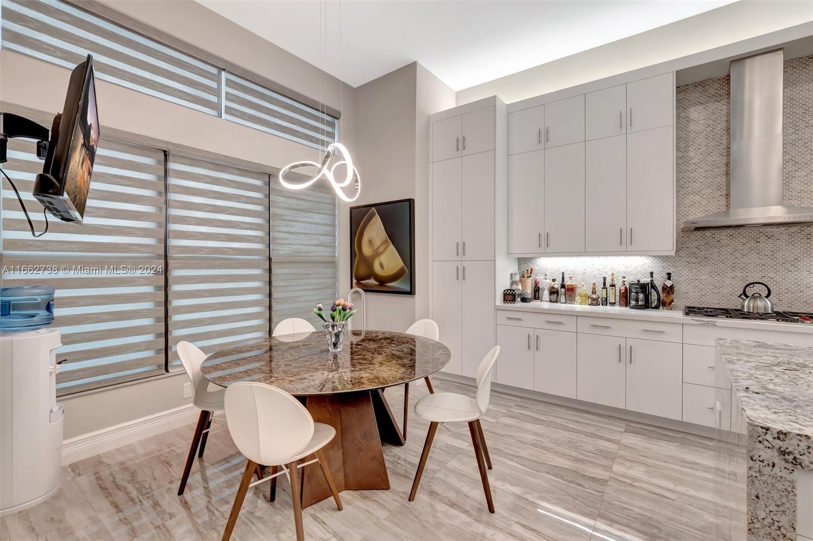 17430 Rosella Road Boca Raton, FL 33496 - Photo 5 of 23 a kitchen with granite countertop white cabinets and white appliances