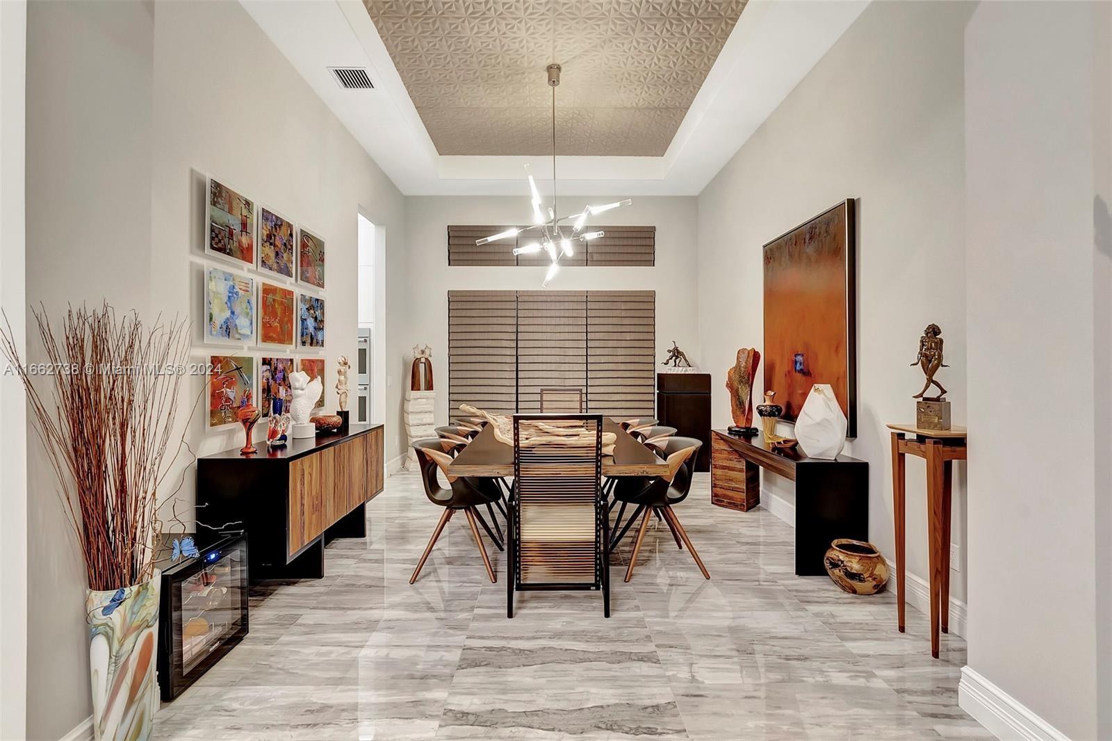 17430 Rosella Road Boca Raton, FL 33496 - Photo 8 of 23 a dining room with wooden floor a chandelier a glass table and chairs