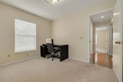 an empty room with windows and furniture