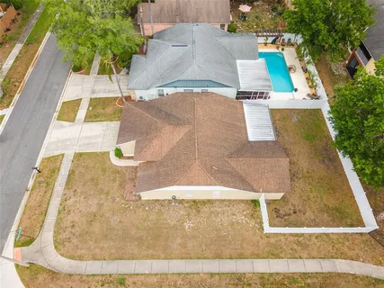 an aerial view of a house with a yard