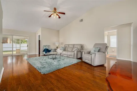 a living room with fireplace furniture and a wooden floor