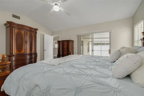 a bedroom with a bed and a large mirror
