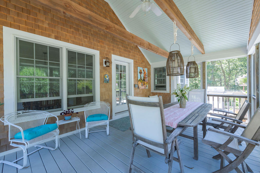 30 Amy's Way Wellfleet, MA 02667 - Photo 18 of 64 a dining room with furniture a chandelier and wooden floor