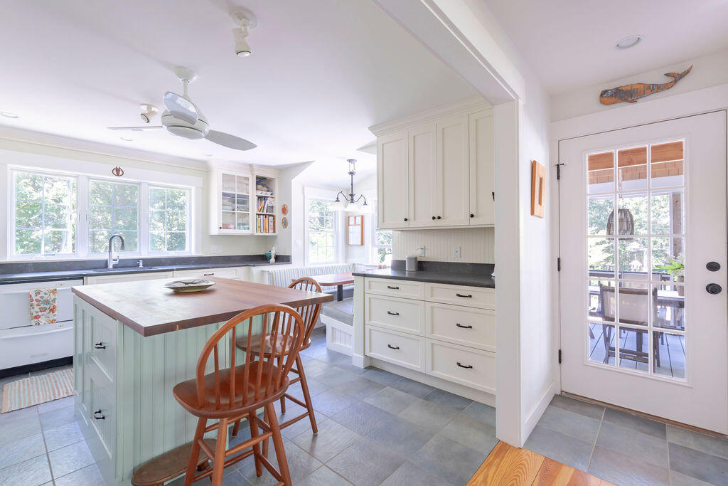 30 Amy's Way Wellfleet, MA 02667 - Photo 2 of 64 a kitchen with a stove a sink a dining table and chairs