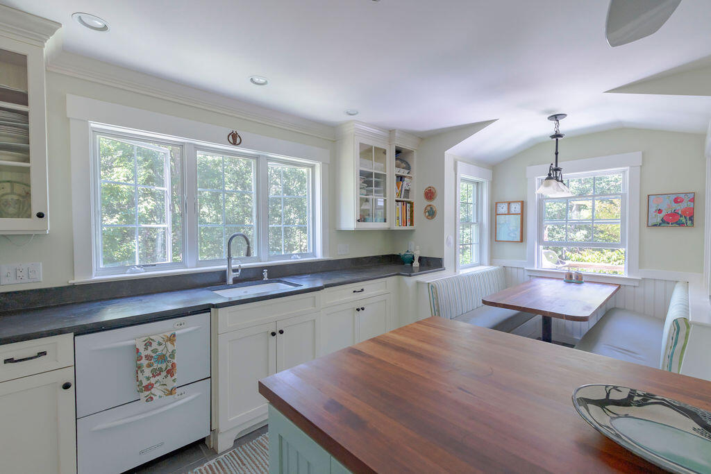 30 Amy's Way Wellfleet, MA 02667 - Photo 25 of 64 a large kitchen with kitchen island a sink dishwasher a stove a dining table and chairs with wooden floor
