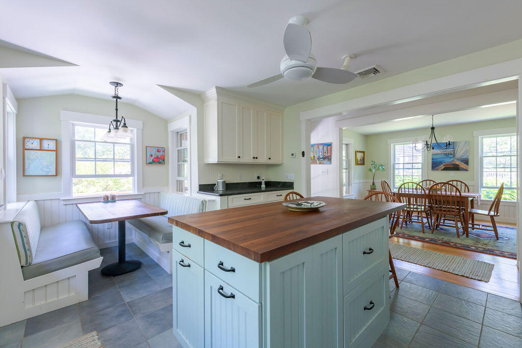 30 Amy's Way Wellfleet, MA 02667 - Photo 27 of 64 a kitchen that has a lot of cabinets a sink and a dining table in it