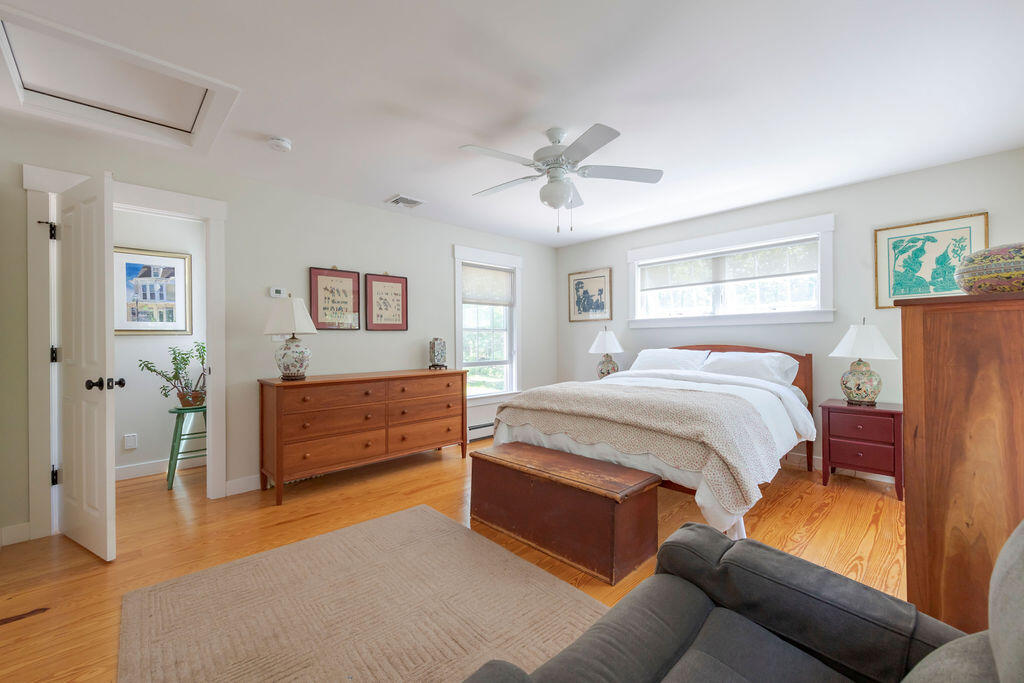30 Amy's Way Wellfleet, MA 02667 - Photo 5 of 64 a spacious bedroom with a bed and a chandelier