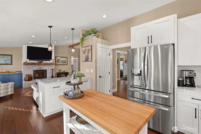 a dining room with furniture a chandelier and wooden floor