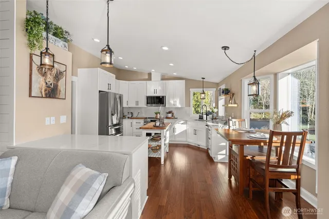 a kitchen with white cabinets and appliances
