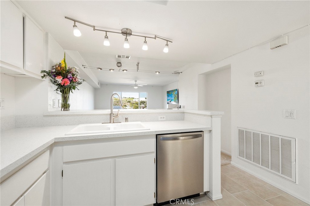 a kitchen with kitchen island white cabinets and chandelier