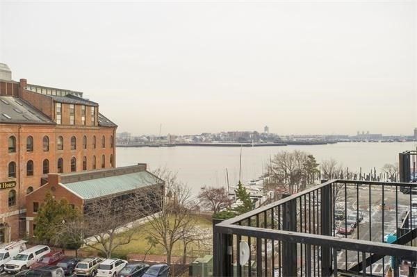 a view of a balcony with wooden floor and lake