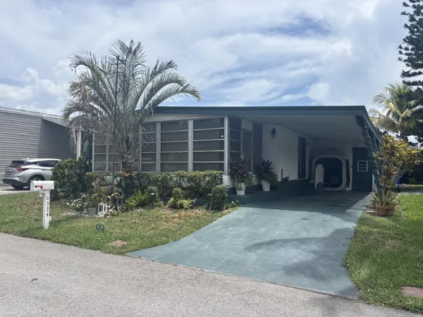a view of a house with a yard and plants