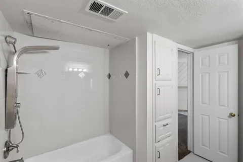 a bathroom with a shower and a glass door