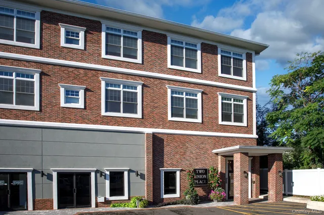 a front view of a building with a garden