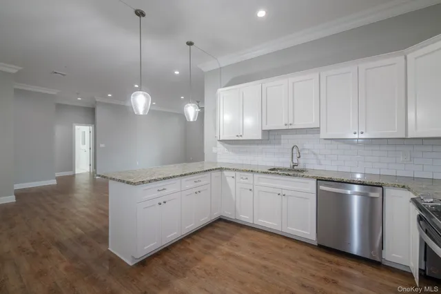 a kitchen with granite countertop white cabinets and white appliances