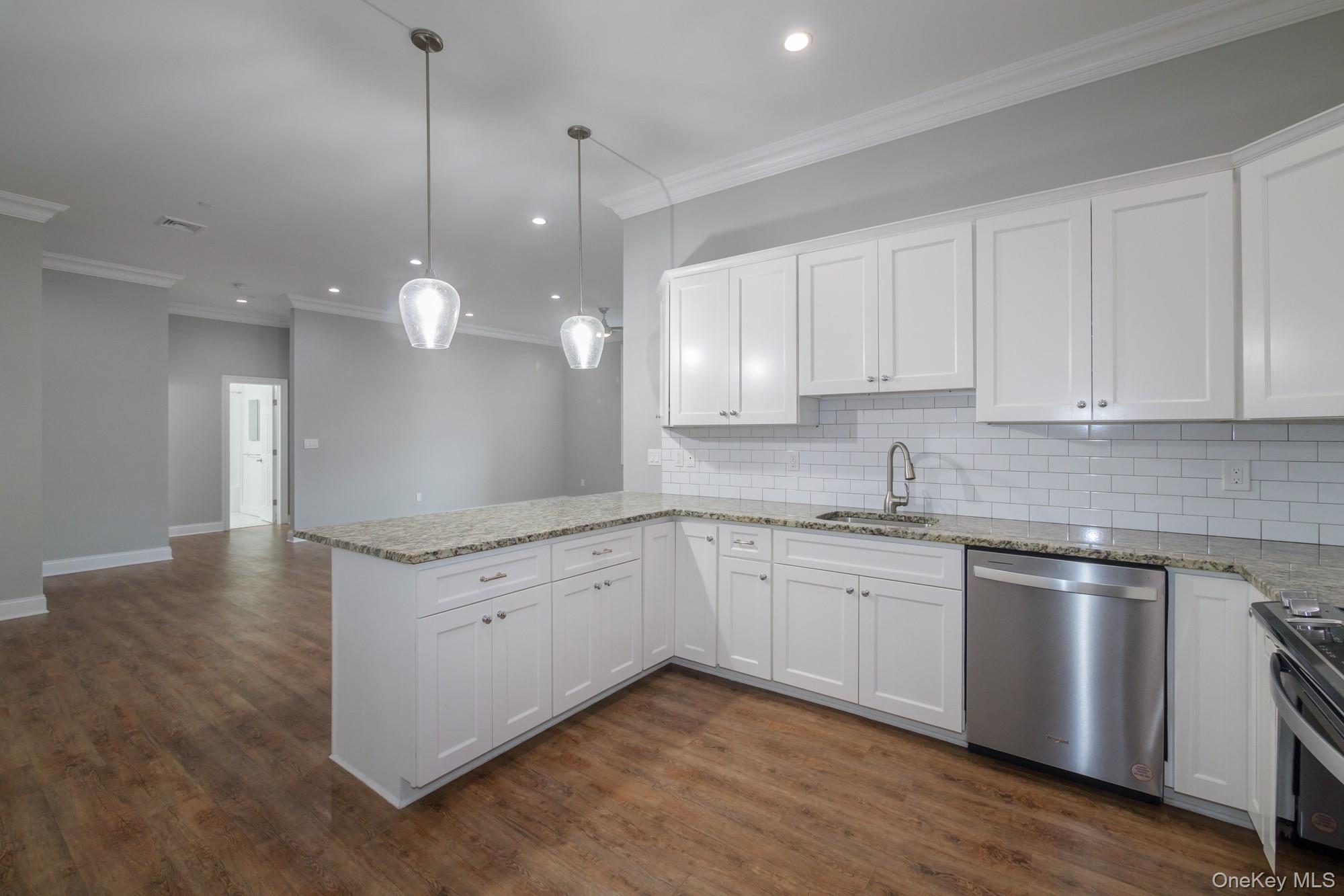 2 Union Place, Unit 3F Huntington, NY 11743 - Photo 3 of 11 a kitchen with granite countertop white cabinets and white appliances
