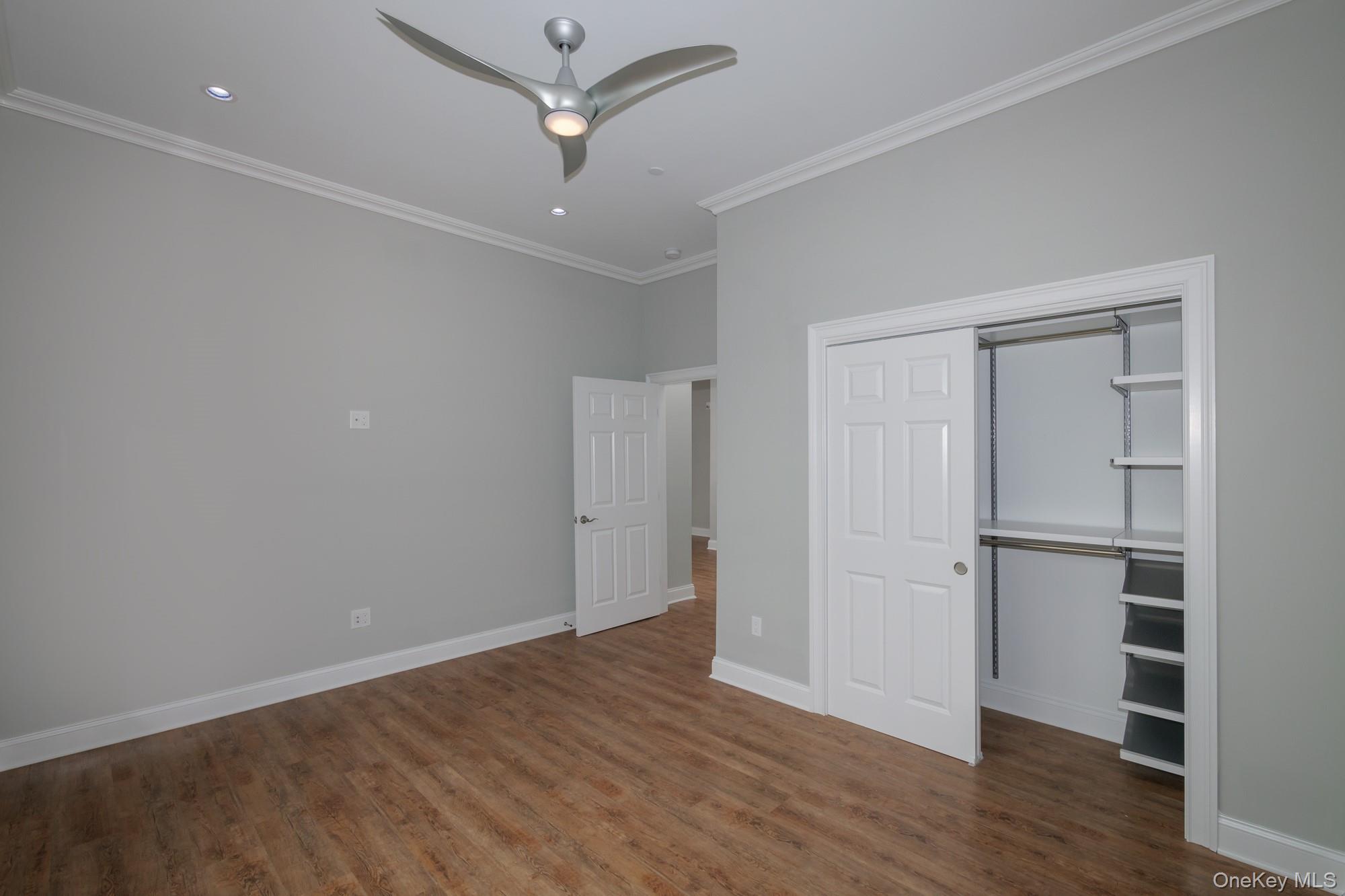 2 Union Place, Unit 3F Huntington, NY 11743 - Photo 9 of 11 an empty room with wooden floor and ceiling fan