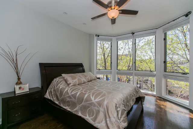 a bedroom with a large bed and a large window