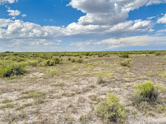 a sign on the wall next to a road