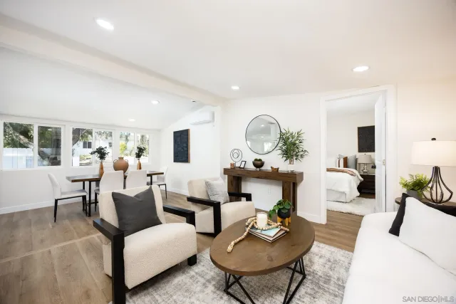 a living room with fireplace furniture and a wooden floor