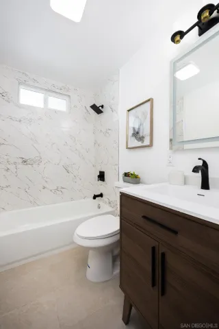 a bathroom with a sink a toilet and a bathtub