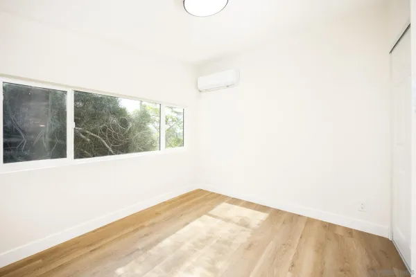 a view of a room with wooden floor and shower