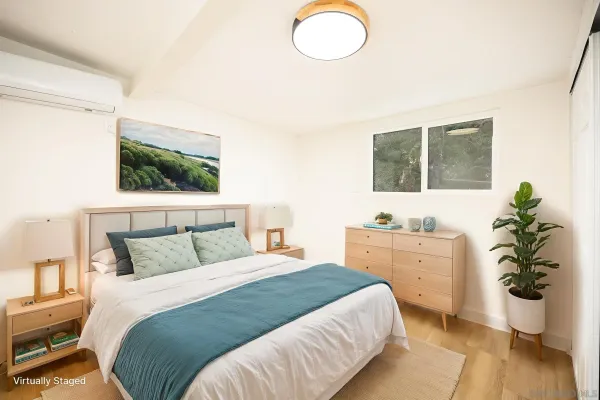 a bedroom with a bed potted plant with the outer view