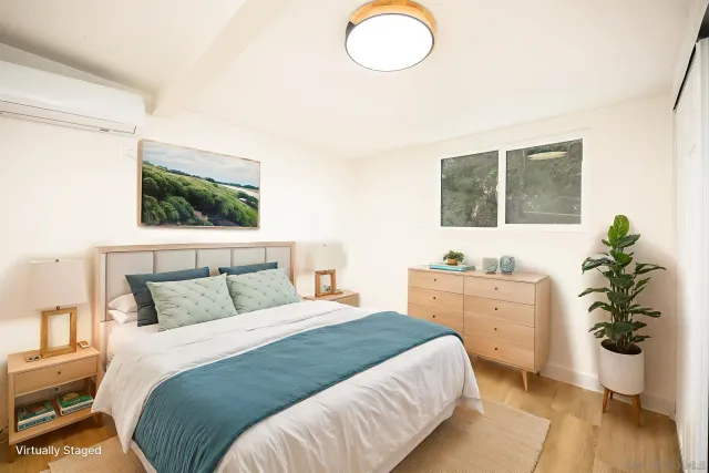 a bedroom with a bed potted plant with the outer view