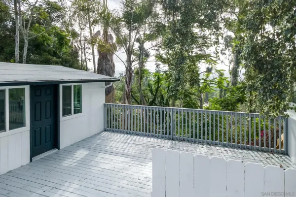 a balcony with trees in front of it
