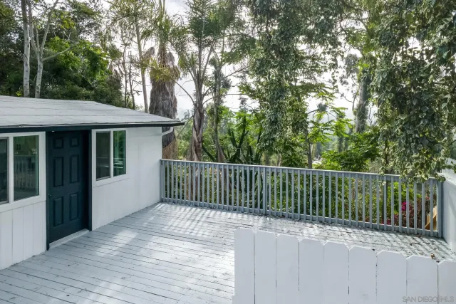a balcony with trees in front of it