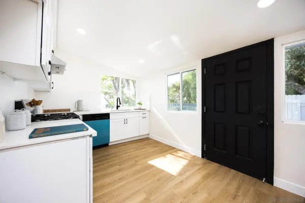 a kitchen with a stove a sink and a refrigerator