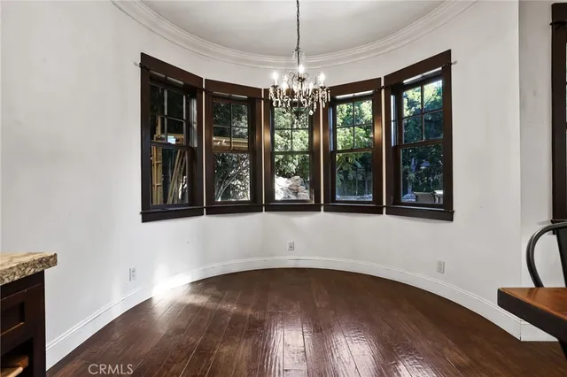 a view of an entryway with wooden floor and windows