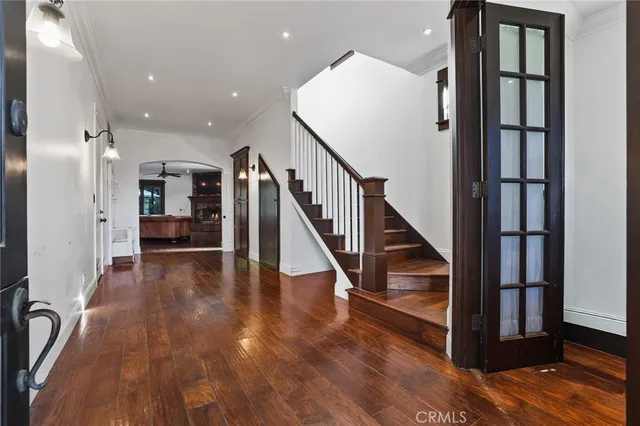a view of entryway and hall with wooden floor