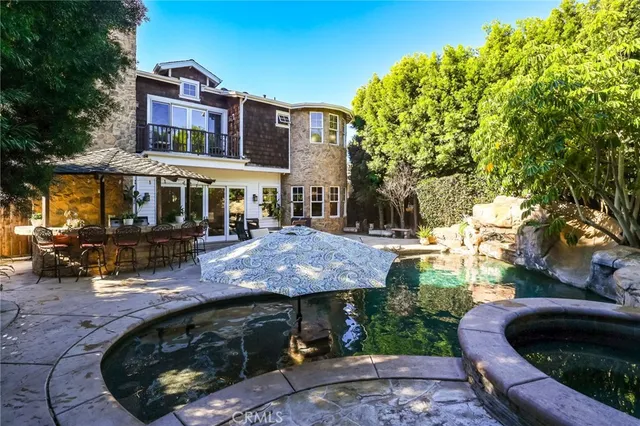 a view of a yard with plants and a barbeque