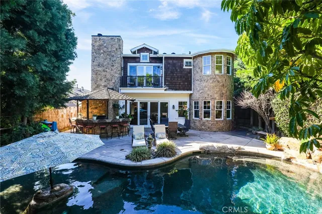 a view of a house with backyard tub and sitting area