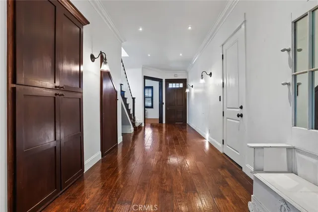 a view of a hallway with wooden floor
