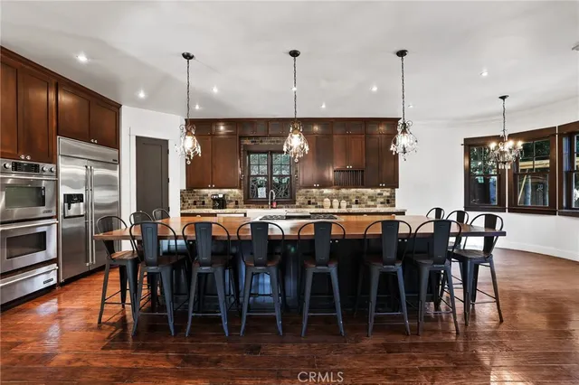 a large kitchen with a table and chairs