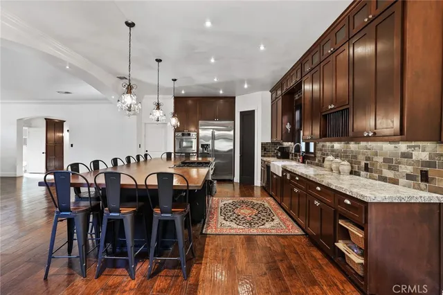 a large kitchen with cabinets table and chairs