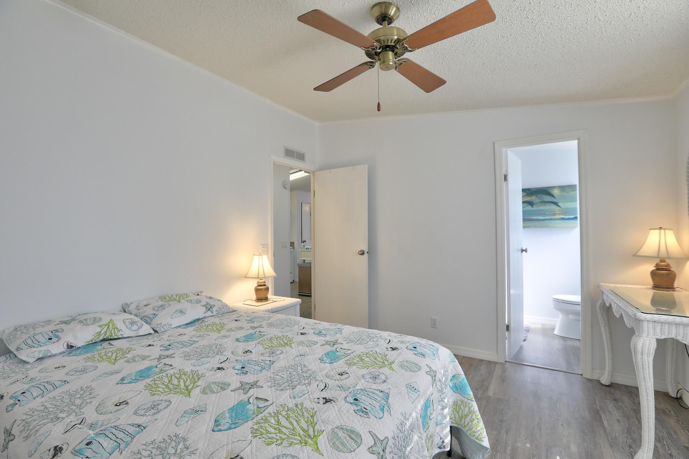 7576 Chasta Road Micco, FL 32976 - Photo 11 of 27 a bedroom with a bed and a chandelier