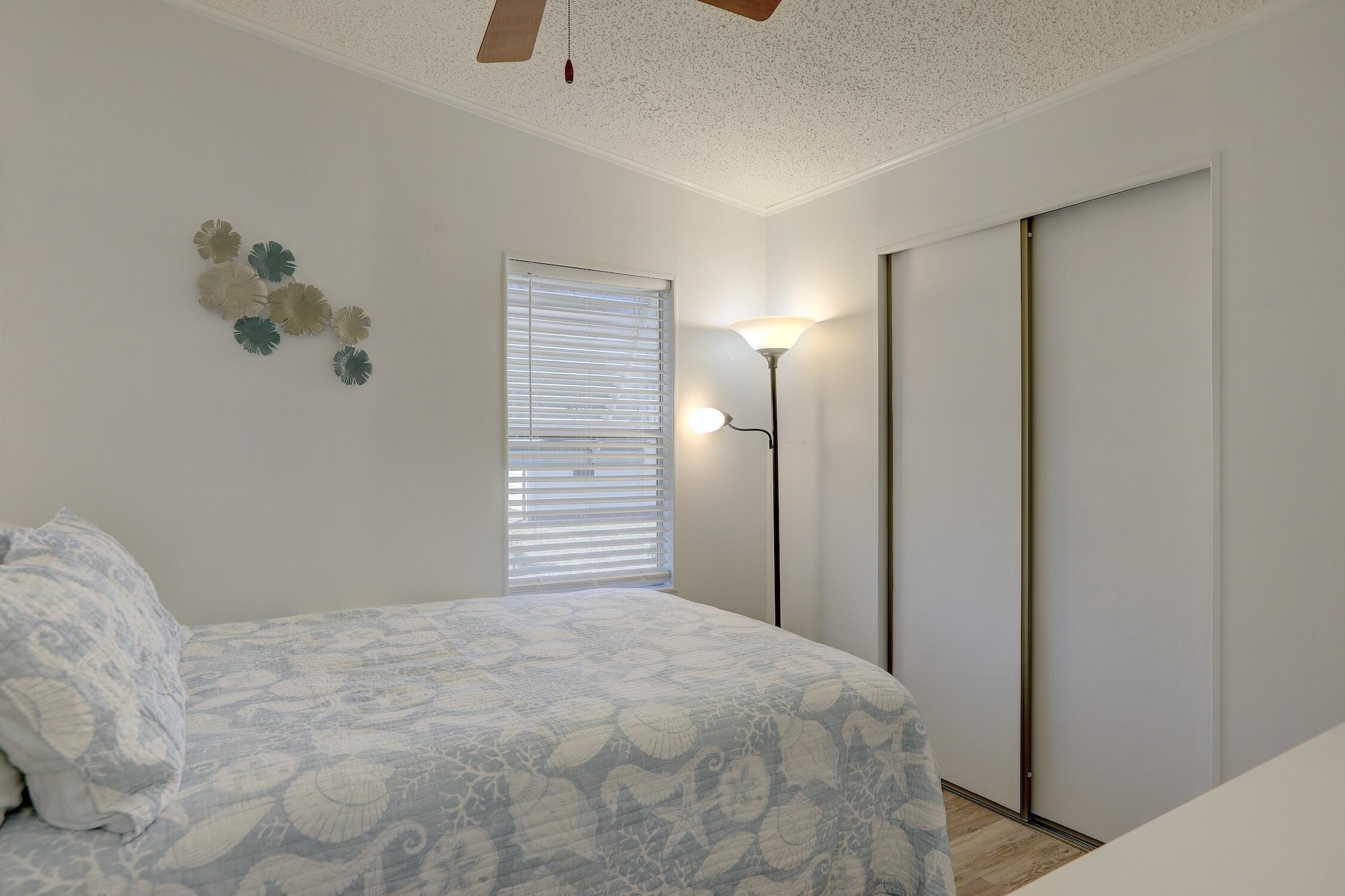 7576 Chasta Road Micco, FL 32976 - Photo 13 of 27 a bedroom with a bed and a window