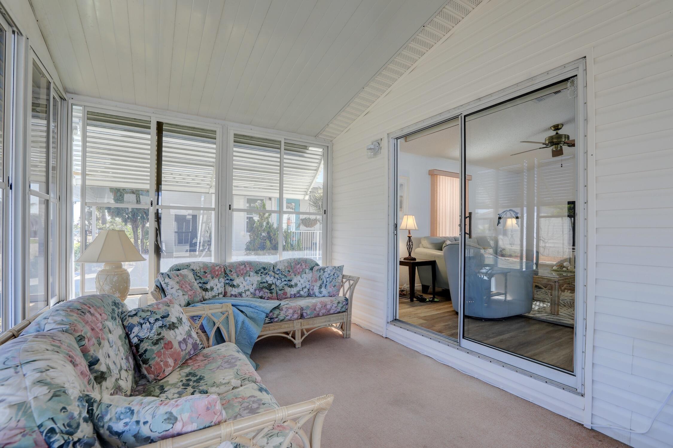 7576 Chasta Road Micco, FL 32976 - Photo 17 of 27 a living room with furniture and a large window