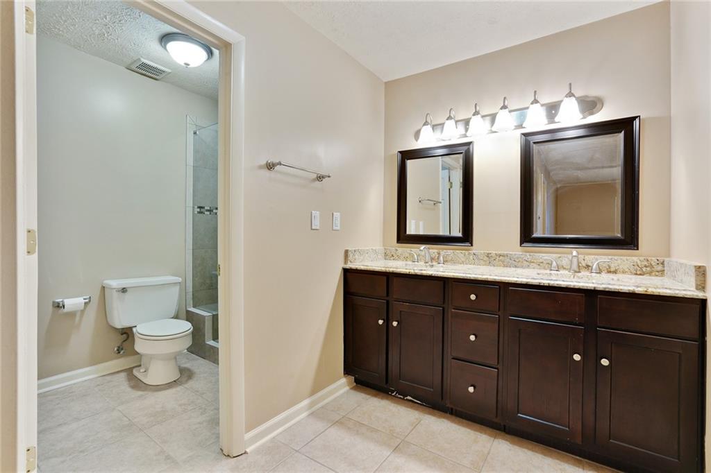 2949 Torreya Way Southeast Marietta, GA 30067 - Photo 15 of 23 a bathroom with a toilet sink double and mirror