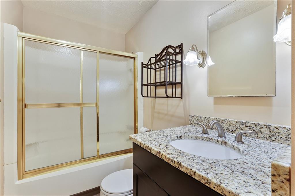 2949 Torreya Way Southeast Marietta, GA 30067 - Photo 19 of 23 a bathroom with a granite countertop sink and a mirror