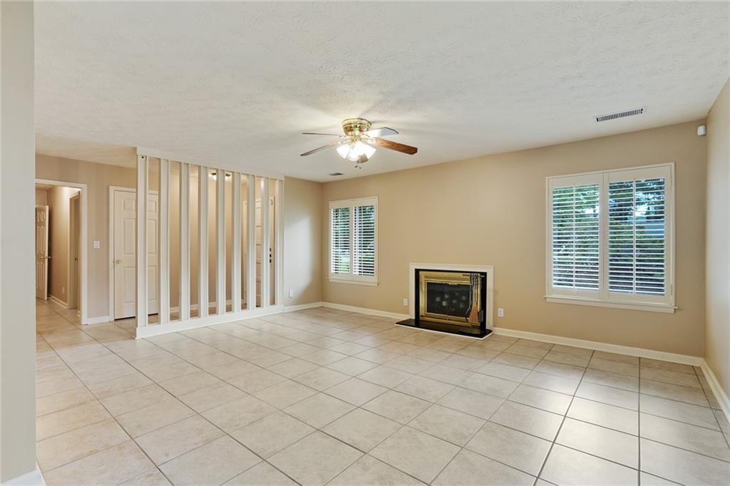 2949 Torreya Way Southeast Marietta, GA 30067 - Photo 3 of 23 a view of an empty room with a fireplace and a window